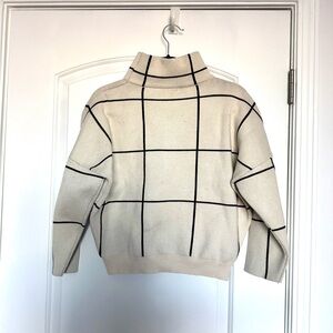 Cream Turtleneck Sweater with Black Grid Pattern